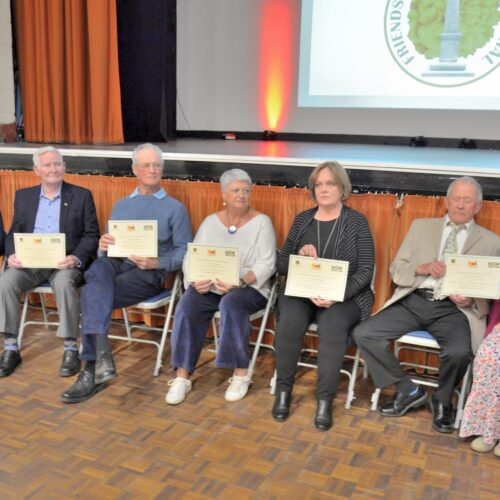 7 nominees for Citizen of the Year seated with their certificates
